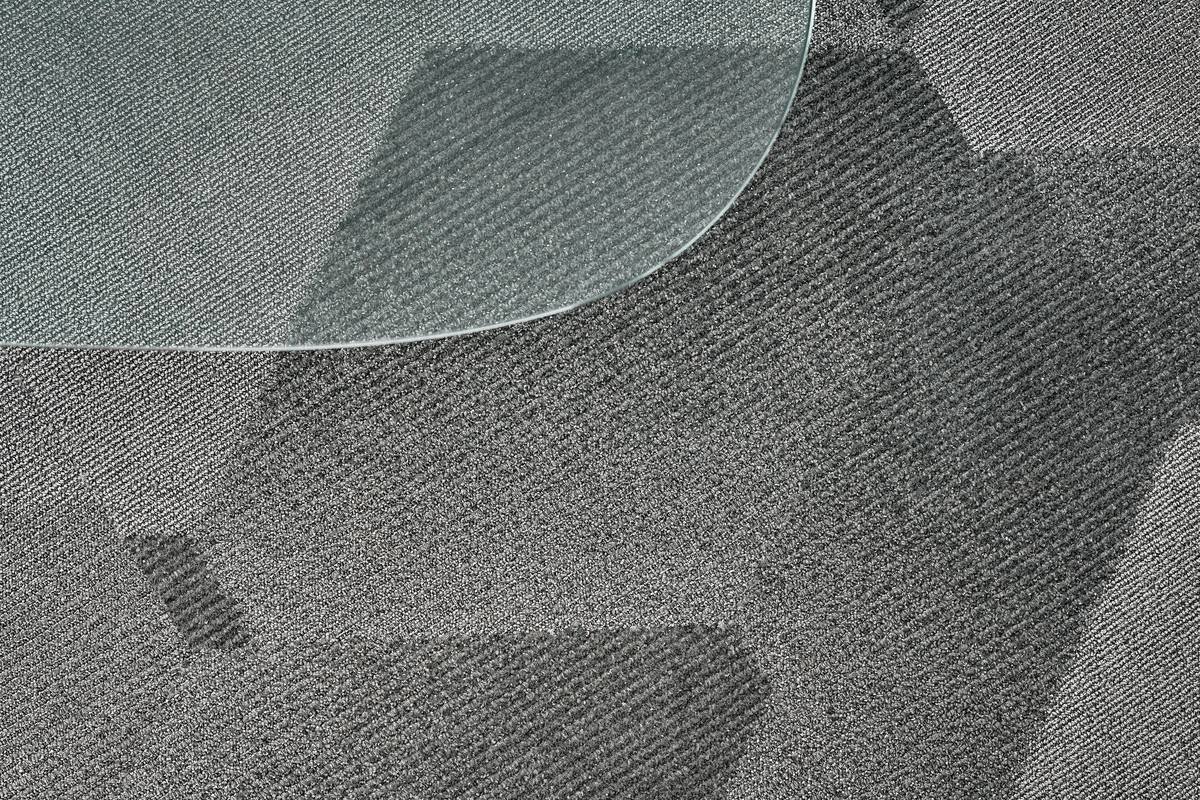 Before and after photos showing stained carpet indentations under furniture legs vs. clean carpet with wide rubber coasters installed