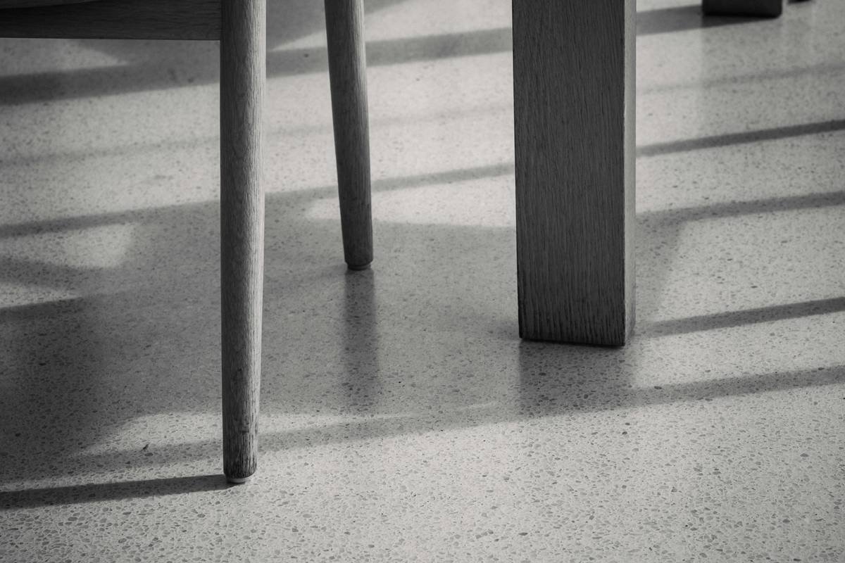 Infographic showing common types of hardwood floor damage caused by unprotected furniture legs vs. protected with proper coasters